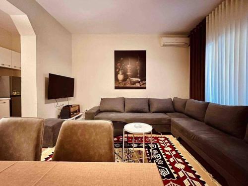 a living room with a couch and a table at Zarlett House, Pazari ri ,Villa with Garden,Parking in Tirana