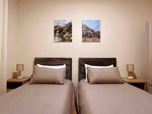 two beds sitting next to each other in a bedroom at Zarlett House, Pazari ri ,Villa with Garden,Parking in Tirana
