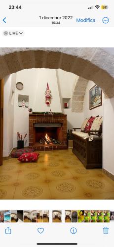 a living room with a fireplace and a couch in a room at Il trullo di nonno Licchio in Alberobello