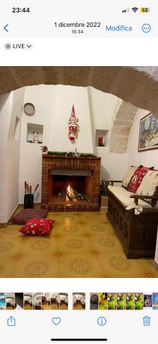 a living room with a fireplace and a couch at Il trullo di nonno Licchio in Alberobello