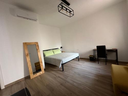 ein Schlafzimmer mit einem Bett, einem Spiegel und einem Stuhl in der Unterkunft Le camere del Nonno Luigi in Neapel