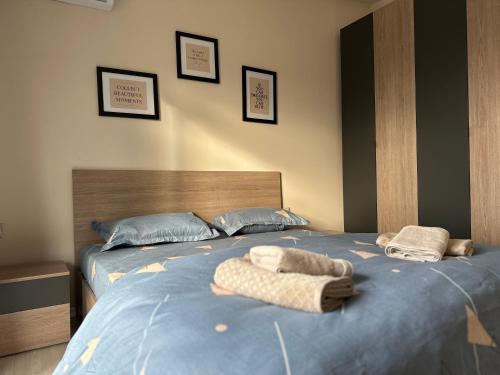 a bedroom with two beds with towels on them at Skyline Panoramic Apartment in Tirana
