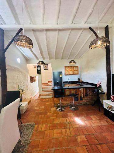 a living room with a table and a television at Hospedaje La Casita de Maria in Barichara