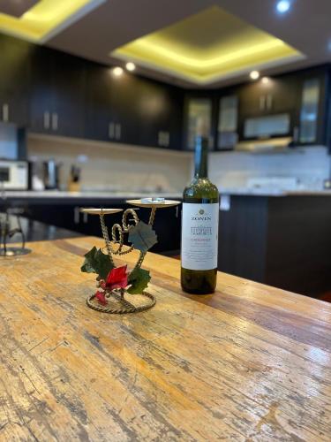 a bottle of wine sitting on top of a wooden table at Casa Elenita in San Juan La Laguna