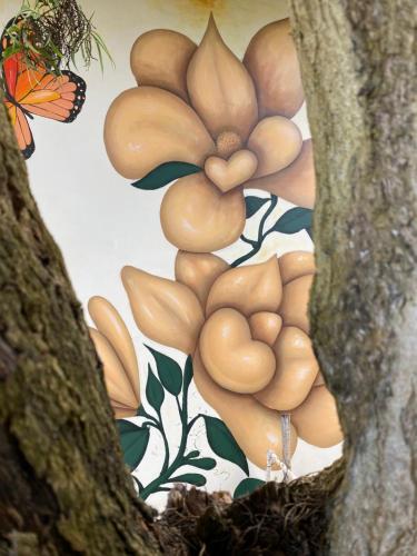a painting of a flower next to a tree at Casa Elenita in San Juan La Laguna