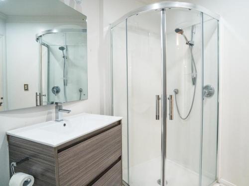 a bathroom with a sink and a shower at U Suites on Manners in Wellington
