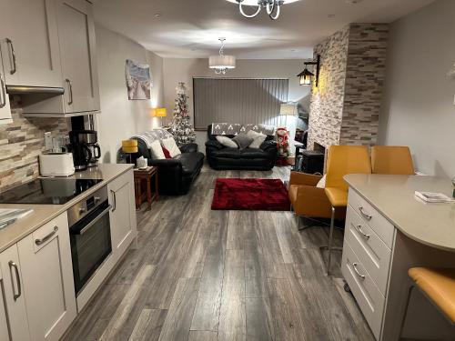 a kitchen and living room with a living room with a couch at Harmony House enclosed property near beach and lake in Tramore