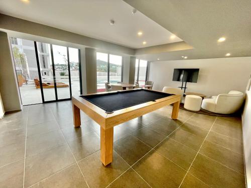 a pool table in the middle of a living room at Cozy condo lake view 15th floor in León