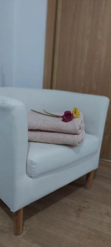 a pile of towels sitting on a white bench at Casa Da Devesa in Nigrán