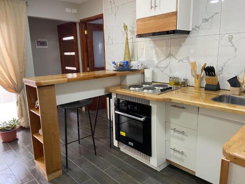 a kitchen with a counter and a stove top oven at Cabañas Bosque Austral in Punta Arenas