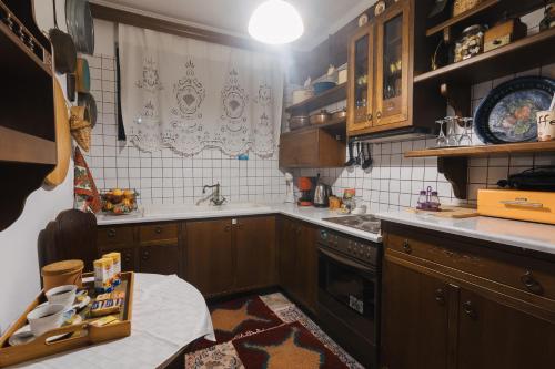 a kitchen with wooden cabinets and a sink at Billiard Home in Trikala in Tríkala