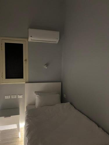 a bedroom with a white bed and a window at Paris east in Cairo