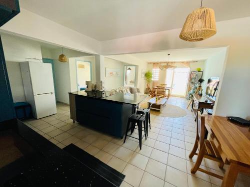 a kitchen and living room with a table and chairs at LA PLAYA - L'Appartement COZY - 2 à 5 personnes in Sainte-Anne