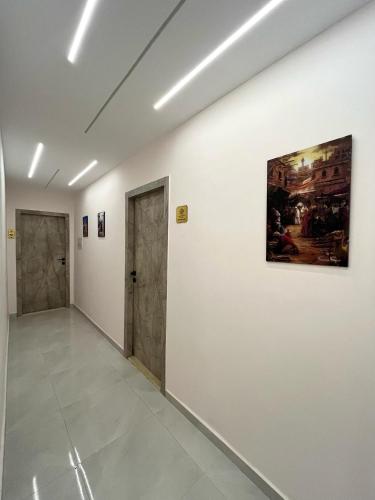 a hallway with two doors and a painting on a wall at Shadow Pyramids Suites and Jacuzzi in Cairo