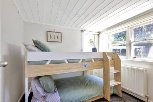 a bedroom with two bunk beds in a room at Dare Street Family Getaway- Walk to beach + shops in Ocean Grove