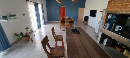 a living room with a long wooden table and chairs at Quinta Loma Hermosa in Aldea Brasilera