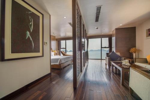 a hotel room with a bedroom and a bed at Cat Ba Paradise Hotel - Sky Bar & Massage in Cat Ba