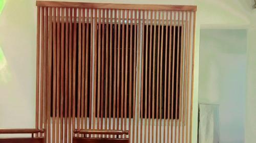 a room with a wooden door with a chair in front at Araliya Uyana Residencies Colombo - Entire House with Two Bedrooms in Colombo