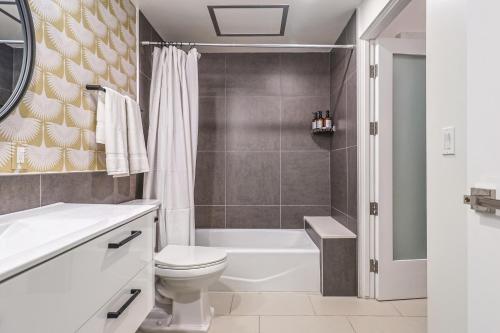 a bathroom with a toilet and a bath tub at Luxury 1bd in Downtown LA in Los Angeles