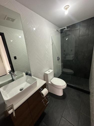 a bathroom with a sink and a toilet and a shower at EON CITY in Guatemala