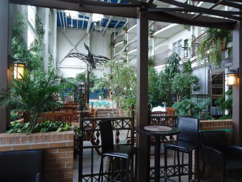 a patio with tables and chairs and plants at Hotel L'Oie des neiges in Lévis