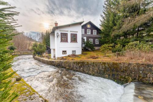 a house with a river in front of it at Chata Amálka in Rokytnice nad Jizerou