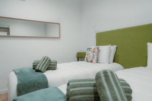 a bedroom with two beds and a couch at Douro Garden - Authentic Portuguese Guesthouse in Vila Nova de Gaia