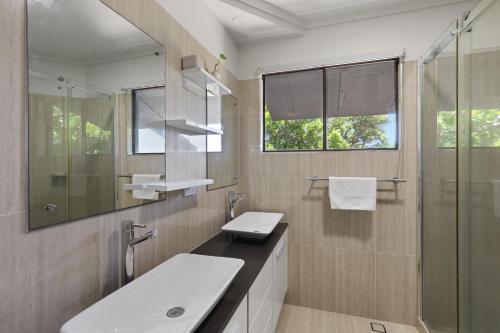 a bathroom with a sink and a shower at Acutterbove in Point Lookout
