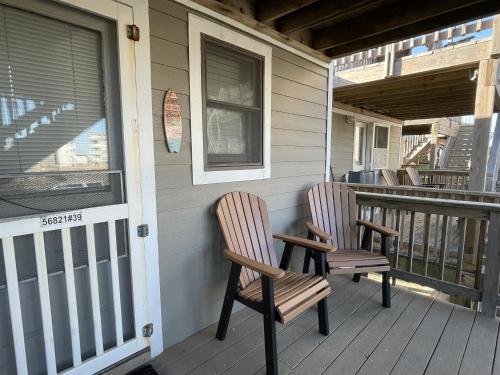 two chairs sitting on the front porch of a house at 39 ALMOST HEAVEN condo in Hatteras