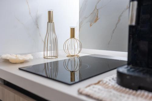 two glass vases sitting on a glass table at Borgo La Chiusa in Cinisi