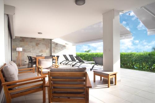 a patio with a bunch of chairs and tables at LA PLAGE MARTINIQUE in Schœlcher