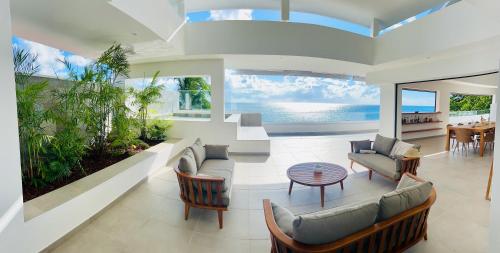 a living room with couches and a table at LA PLAGE MARTINIQUE in Schœlcher