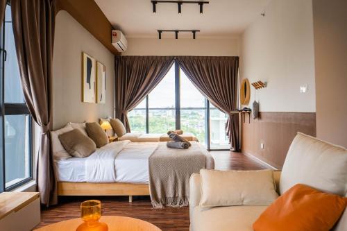 a bedroom with a bed and a large window at K Avenue by Pinstay in Donggongon