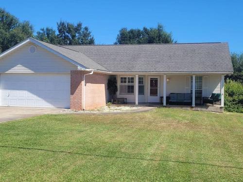 a house with a lawn in front of it at Beautiful 3 bedroom home 4 minutes from the beach in Pensacola