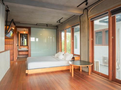 a bedroom with a bed and a table at SMARANALA in Nusa Dua