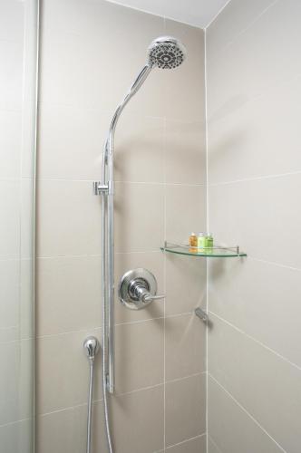 a shower with a glass door with a glass shelf at Stylish Suite at 300 Front Street W in Toronto