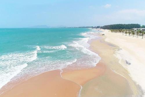 an aerial view of a beach with the ocean at The Song Vung Tau By Abogo in Vung Tau