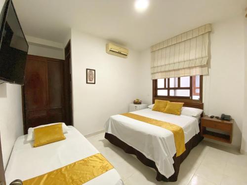 Postel nebo postele na pokoji v ubytování Hotel San Julian