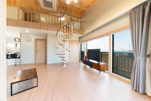 a living room with a view of the ocean at Geumdanyoung Pension in Jeju