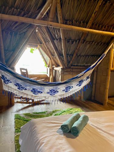 two towels laying on a bed in a hammock at Guajira Beach in Ríohacha