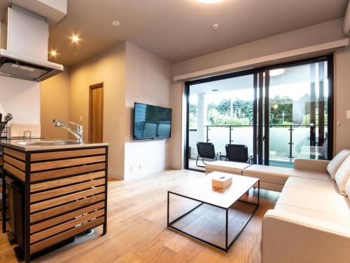 a living room with a couch and a table at Rakuten STAY MOTEL Nikko Kinugawa in Nikko