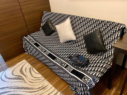 a black and white couch with pillows on it at Penthouse Perfection in Manila