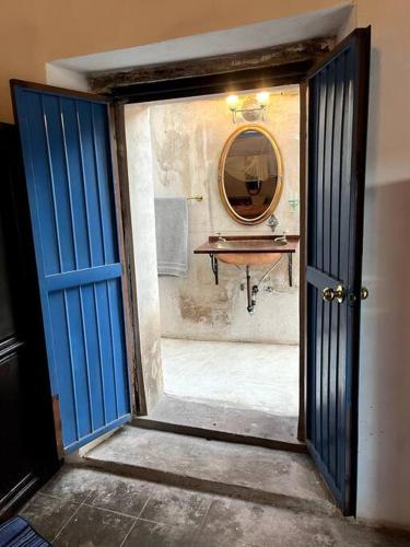 a doorway to a bathroom with a sink and a mirror at Casa de Flaco in Álamos