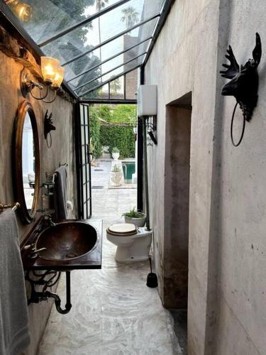 a bathroom with a sink and a toilet at Casa de Flaco in Álamos