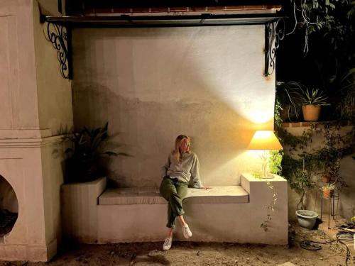 a woman sitting on a couch in a room at Casa de Flaco in Álamos