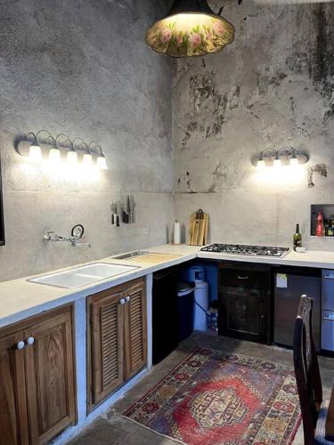 a kitchen with a sink and a stove top oven at Casa de Flaco in Álamos