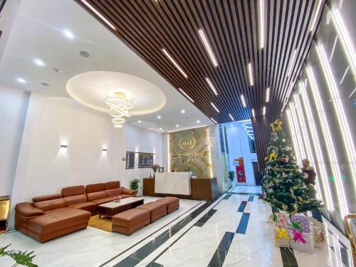 a living room with a christmas tree in a building at H&T Luxury Hotel in Sa Pa