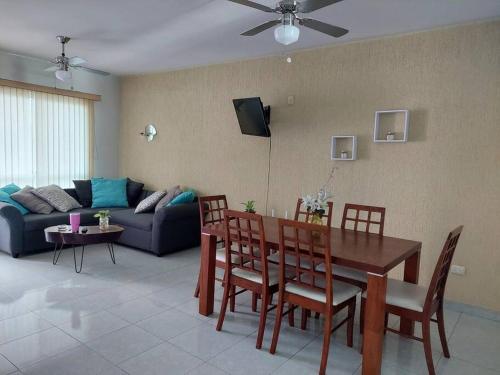 - un salon avec une table, des chaises et un canapé dans l'établissement Departamento en el centro de boca del rio, à Boca del Río