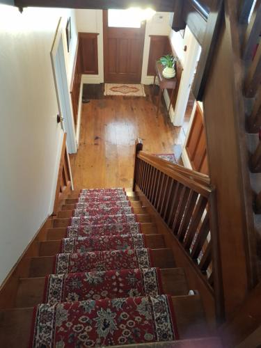 an overhead view of a stairway with a rug on it at Riverhead Villa in Horoeke