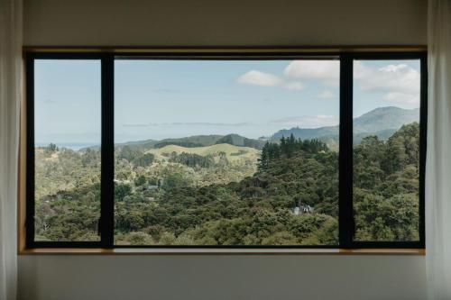 a window with a view of a mountain view at Buffalo Lodge in Coromandel Town